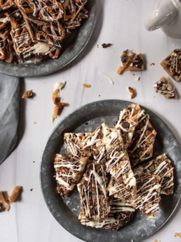 english toffee topped with pecans and white chocolate drizzle