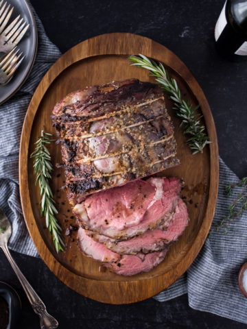 perfect medium rare prime rib roast on wooden platter