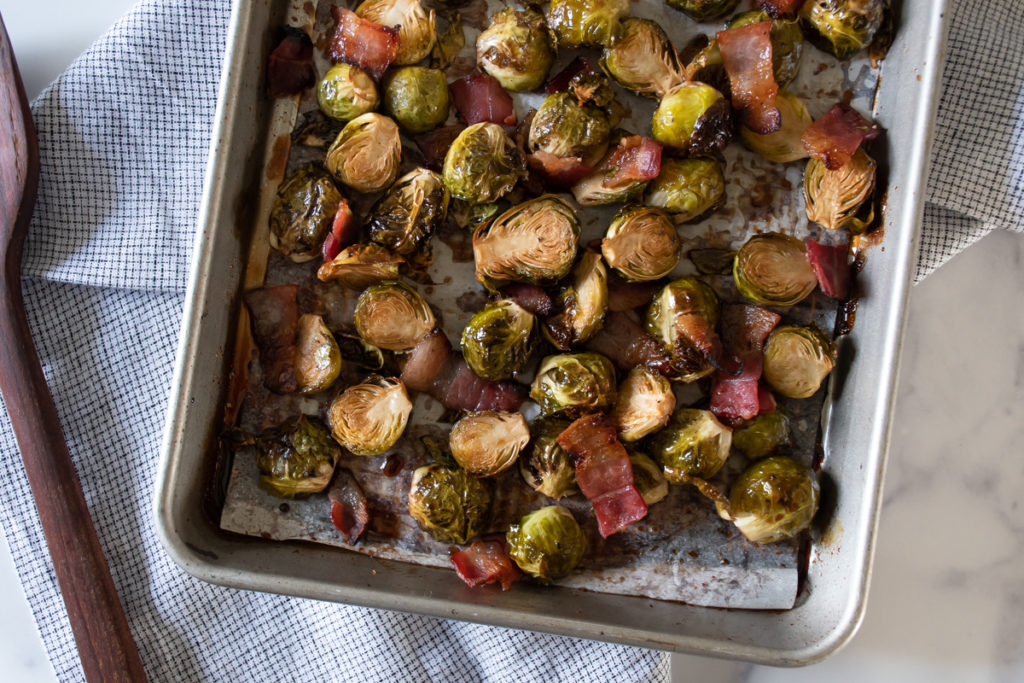 caramelized brussels sprouts and bacon on a tray