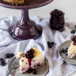 creamy cheesecake with blueberry swirls topped with blueberry sauce