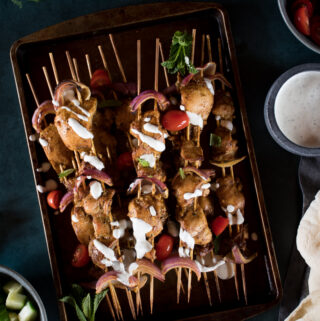 grilled chicken shawarma on wooden skewers