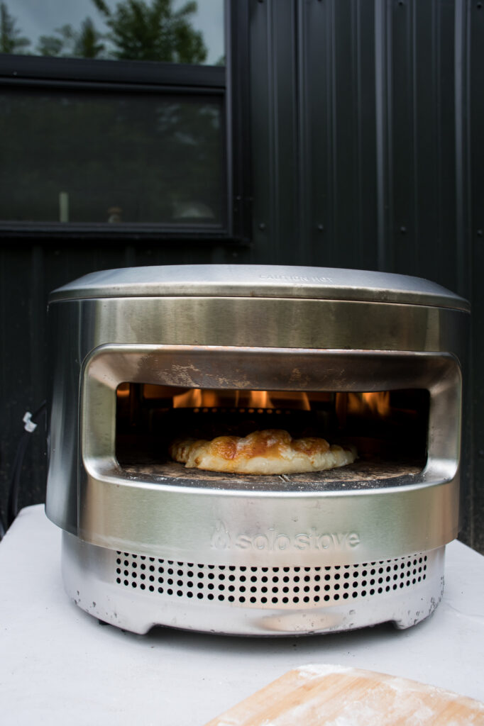 solo stove pi pizza oven cooking a sourdough crust pizza